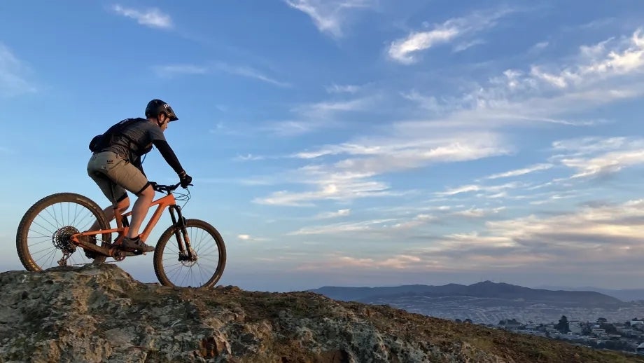A person on a mountain bike overlooking a beautiful view.