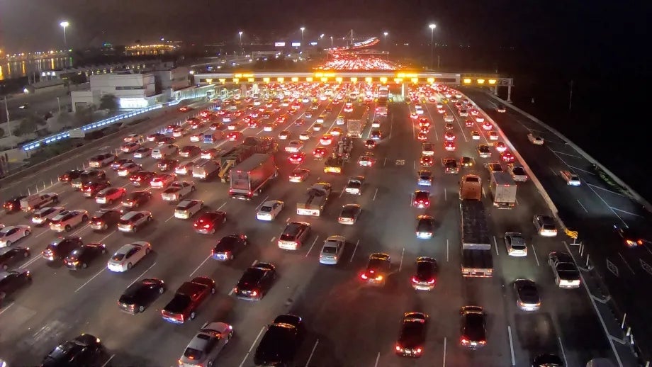 Heavy traffic at the toll plaza on the San Francisco-Oakland Bay Bridge in the early morning hours before dawn.