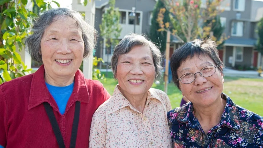 Three smiling Asian senior women.