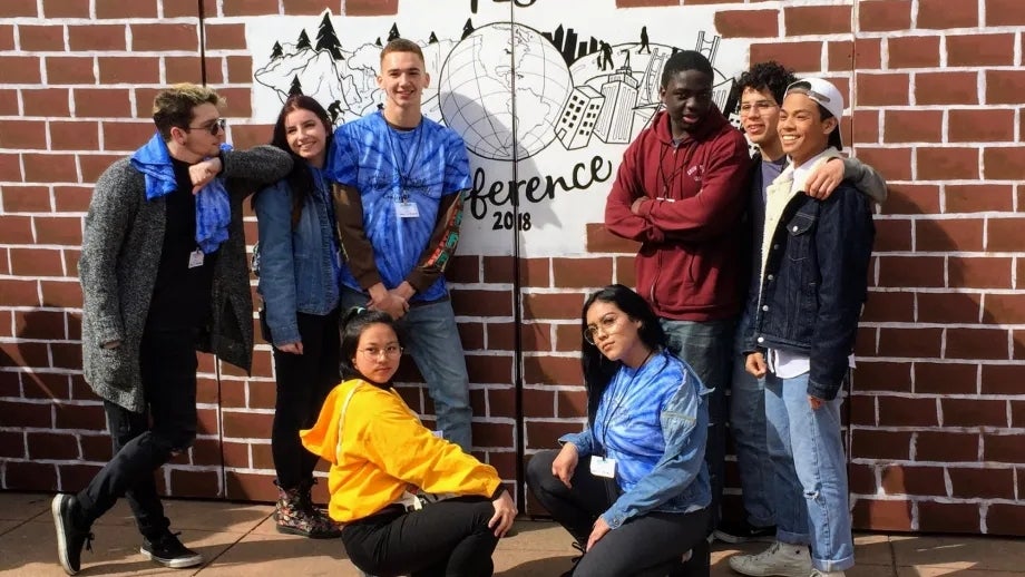 A group of 8 students pose at the 2018 YES Conference.