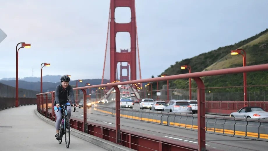 A cyclist rides across the Golden Gate Bridge on Bike to Work Day.