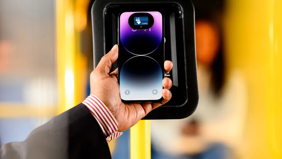 A person using Google Wallet on their Android phone to pay for transit.