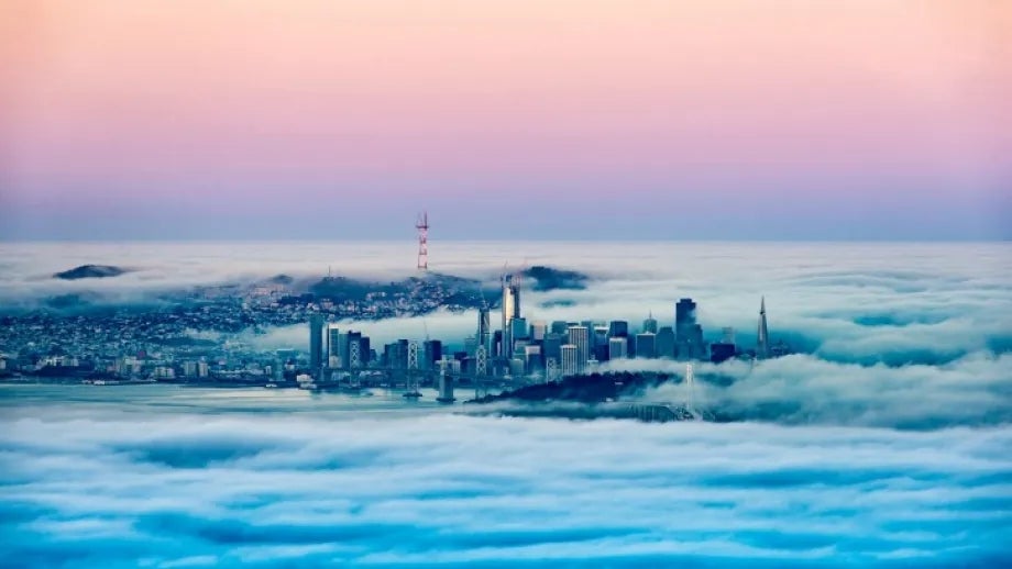 Fog surrounds San Francisco, where only downtown skyscrapers and the Sutro Tower are visible.
