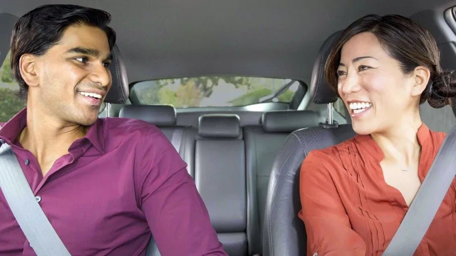 Carpoolers smiling at each other, clearly mutually attracted, but nervous to say so